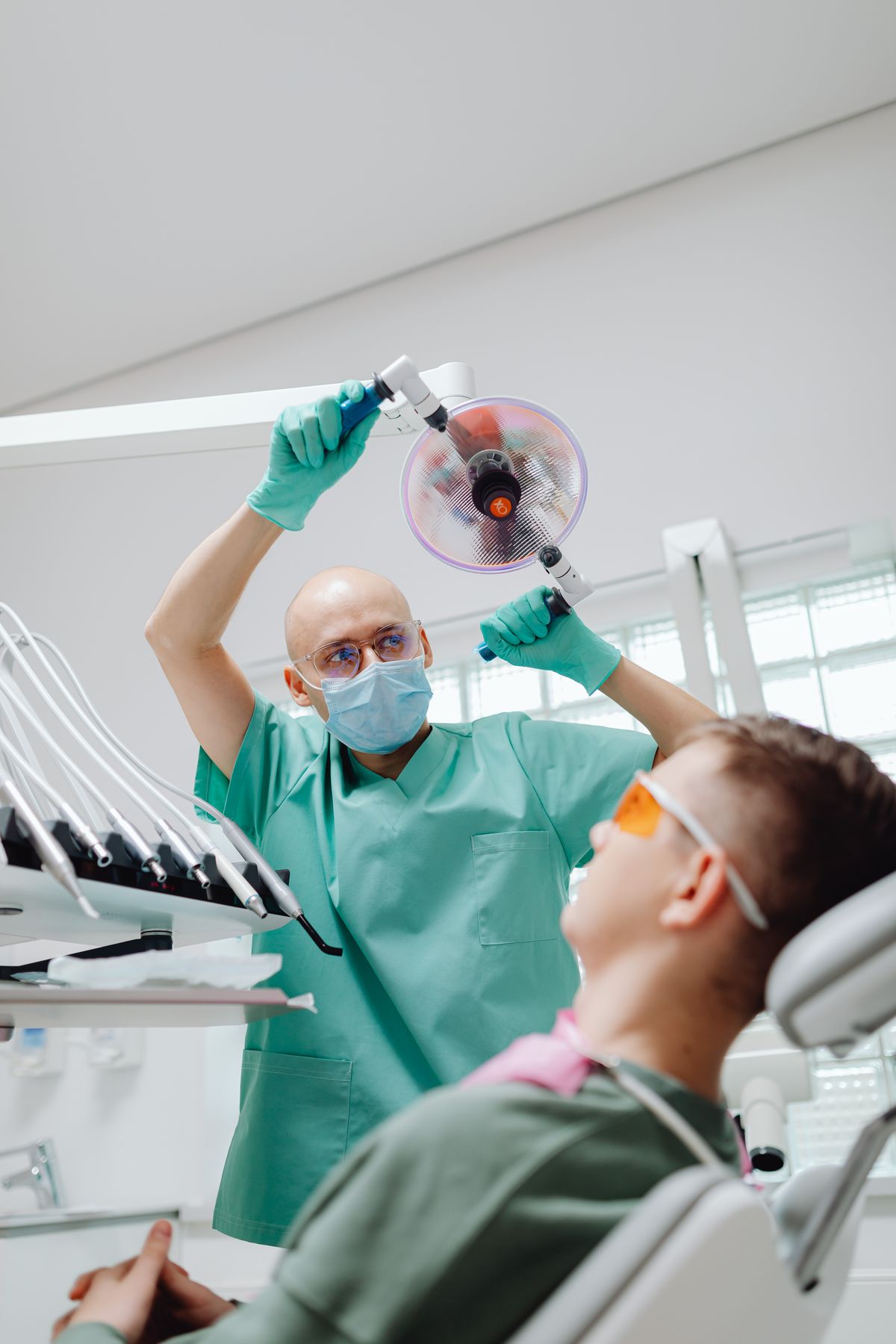 Dentist preparing to treat a patient in the dental chair