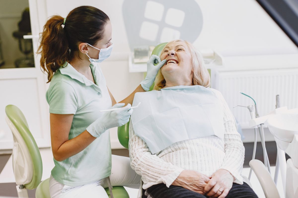 Dentist sharing a laugh with a relaxed patient during treatment